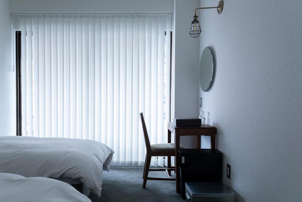Postel nebo postele na pokoji v ubytování BENJAMIN HOTEL KANAZAWA