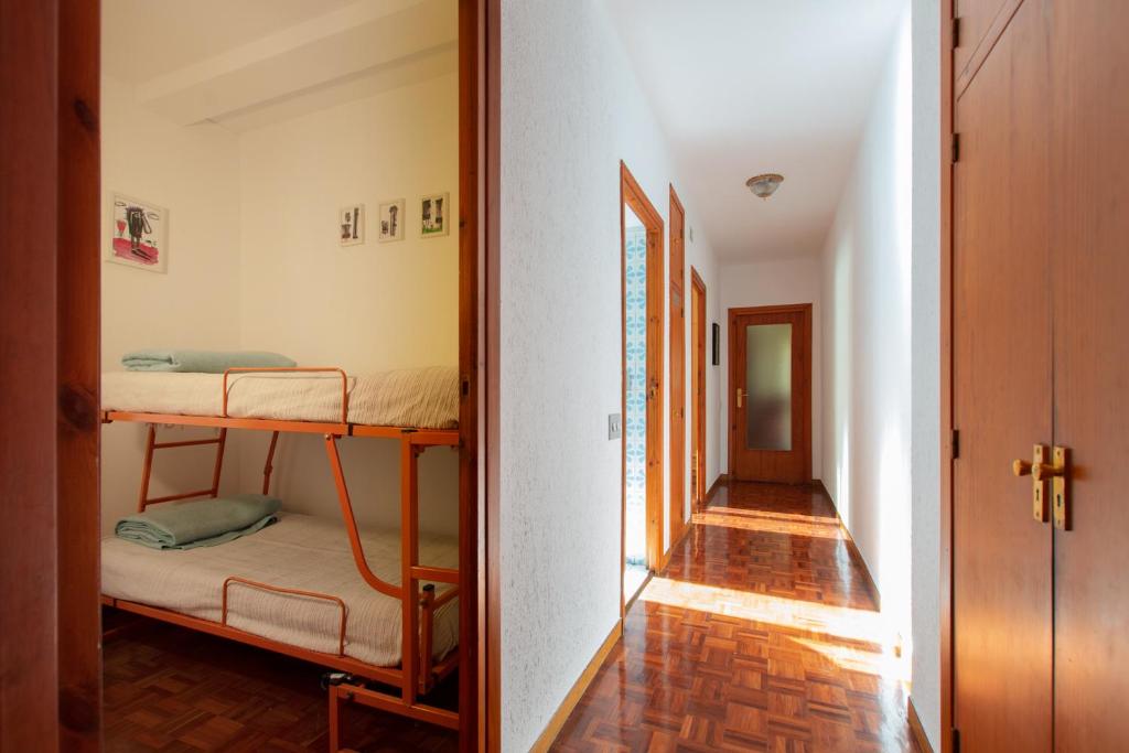 a hallway with two bunk beds in a room at La Martina, Parking incluido in Jaca