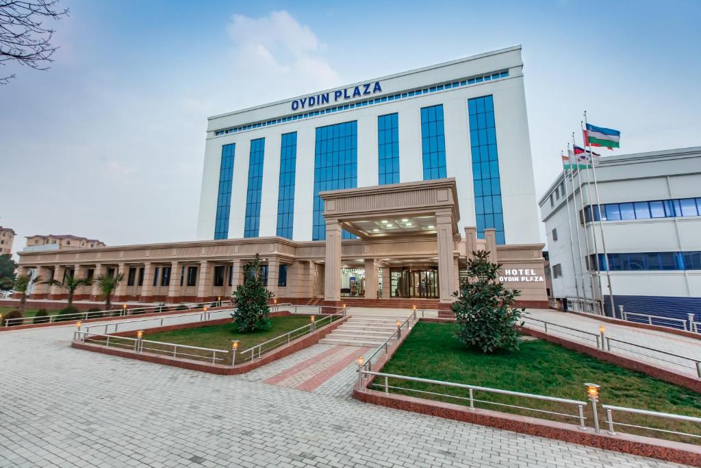 a building with a sign on top of it at OydinPlaza Hotel in Namangan