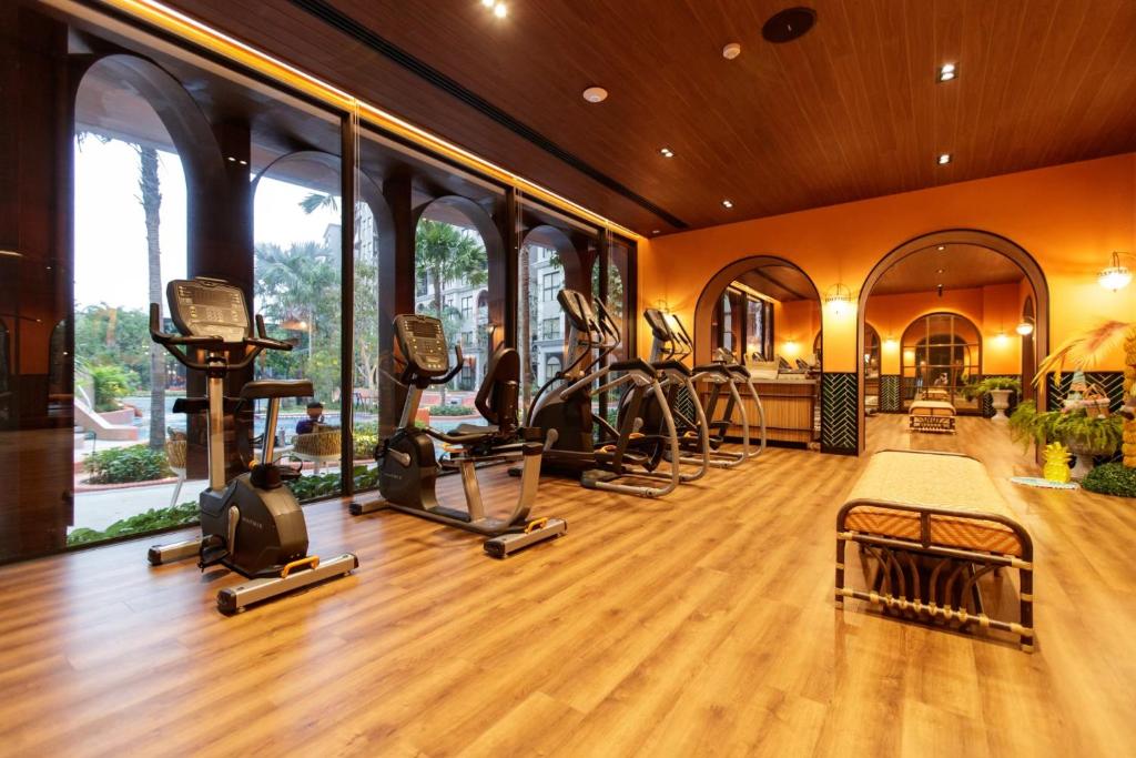 a gym with treadmills and ellipticals in a building at La Habana in Hua Hin