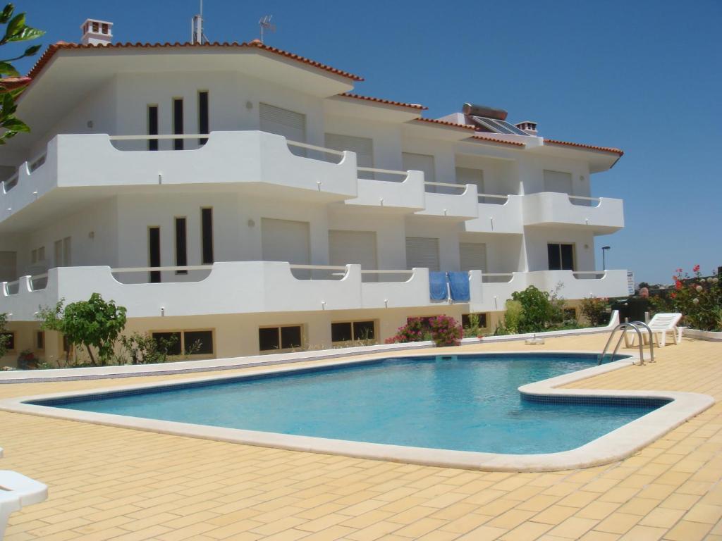 a building with a swimming pool in front of a building at Apartamentos Sonybell in Albufeira