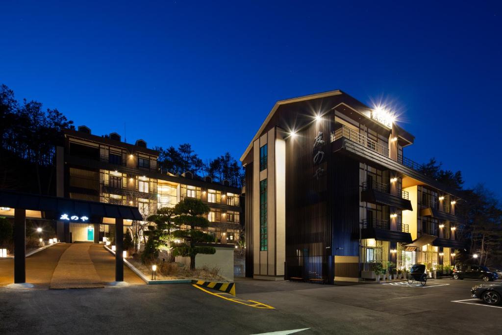 a building with a parking lot at night at Tomonoya Hotel and Ryokan Gyeongju in Gyeongju