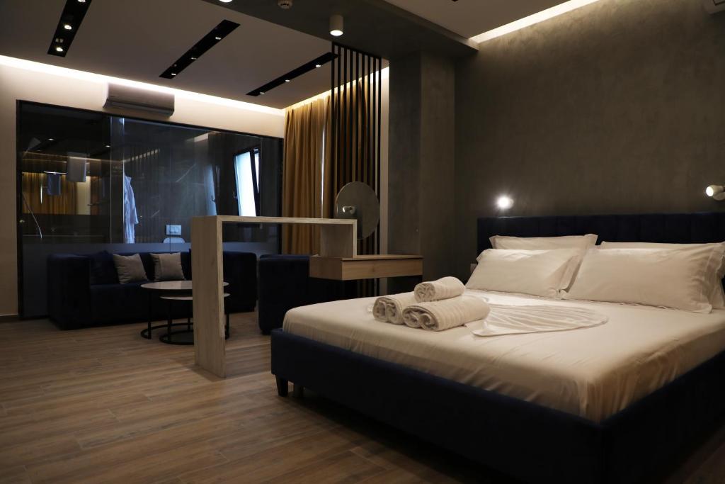 a bedroom with a bed with towels on it at Hotel Triumf Shengjin in Shëngjin