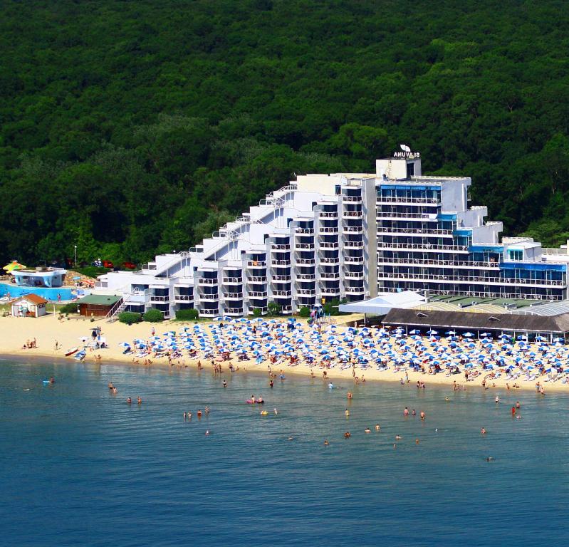 a beach with umbrellas and people in the water at Hotel Slavuna in Albena