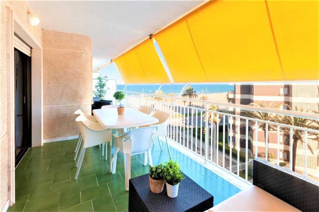 a balcony with a table and a view of the beach at AG AGUAMARINA 5 in Gandía