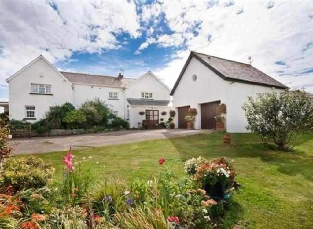 a large white house with a yard at 1-Bed Cottage on Coastal Pathway in South Wales in Gileston