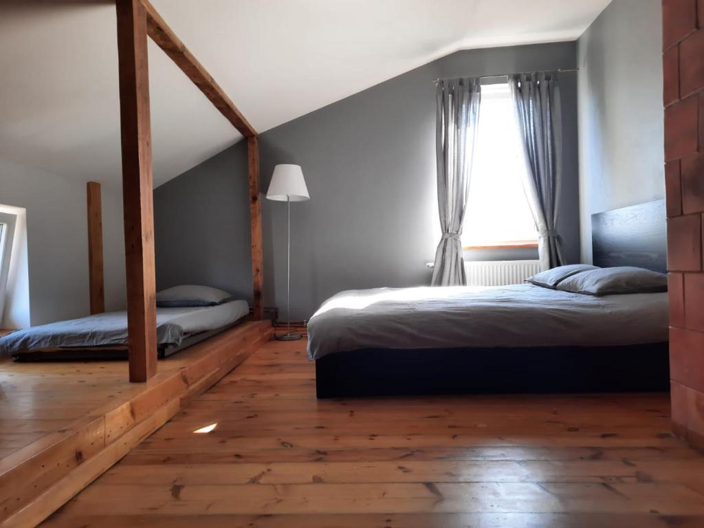 a bedroom with two beds and a window at Apartment Uliha in Liepāja