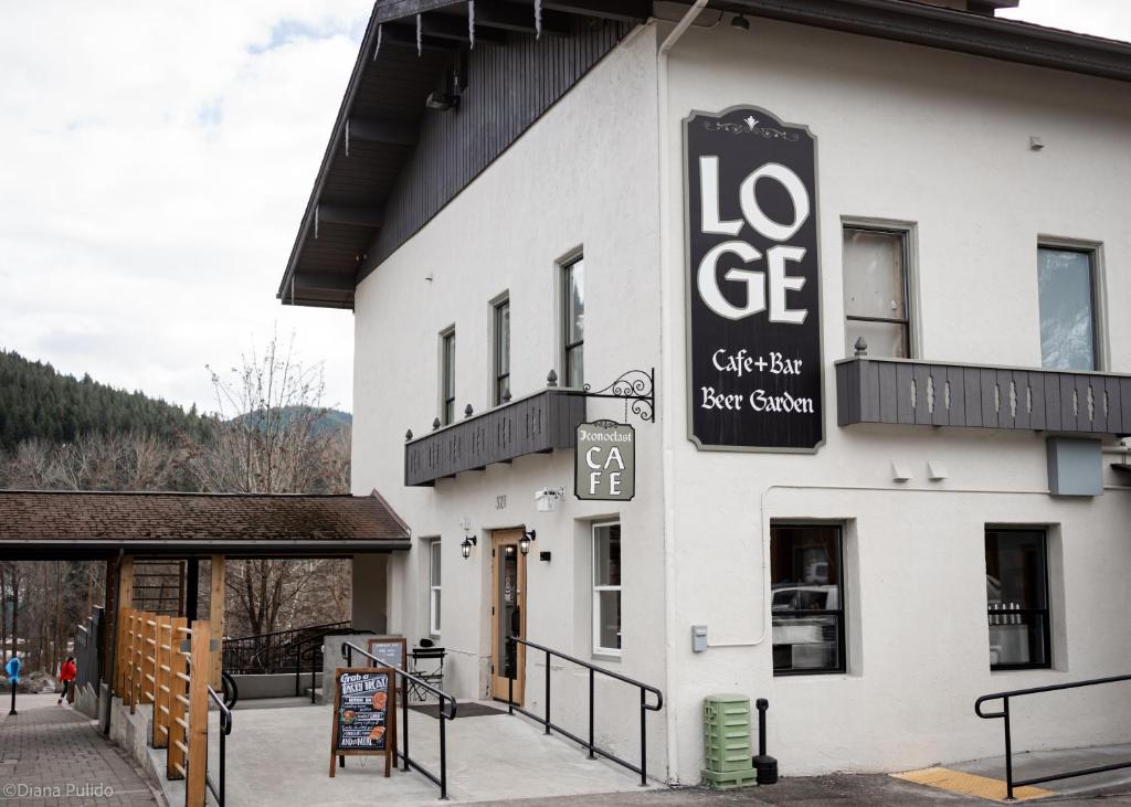 a white building with a sign for a restaurant at LOGE Leavenworth Downtown in Leavenworth