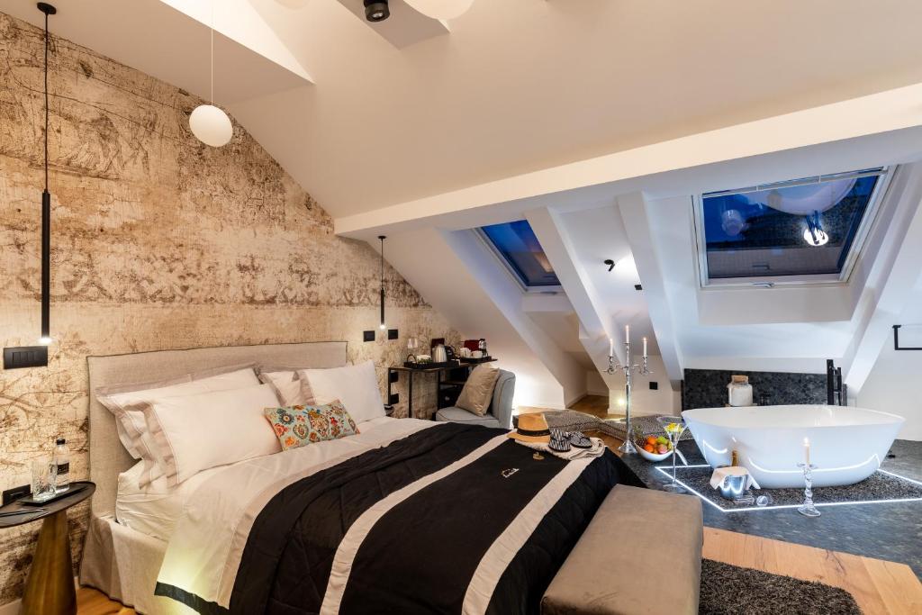 a bedroom with a large bed and a bath tub at La Vita e Bella V in Dubrovnik