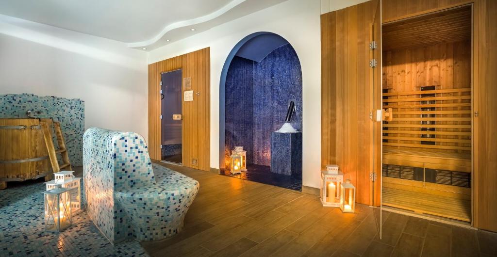 a living room with a chair and a window at Valamar Diamant Hotel in Poreč