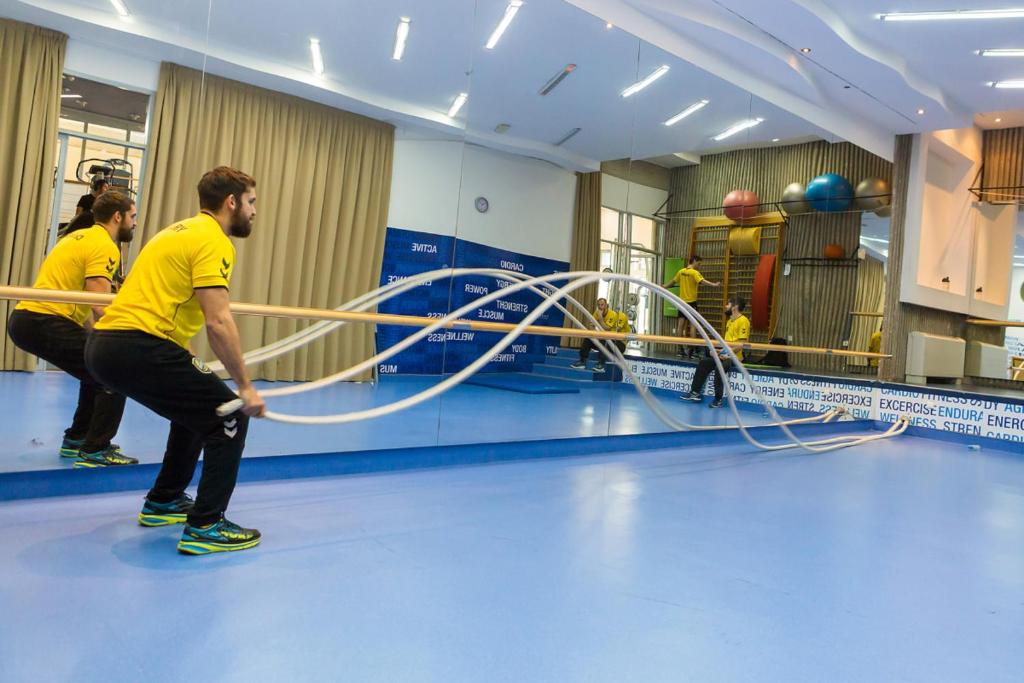 a group of people playing with a volley ball hoop at Valamar Diamant Hotel in Poreč