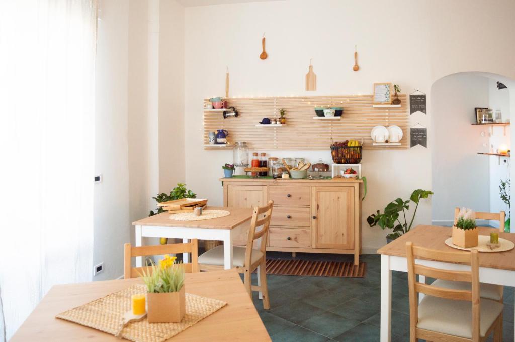 a kitchen and dining room with tables and a counter at PURA B&b in Noicattaro