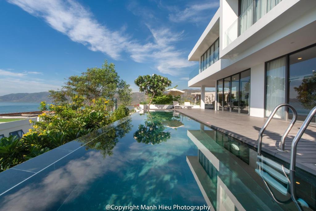 an infinity pool in a house with a view of the ocean at Casa Blanca Villas in Nha Trang