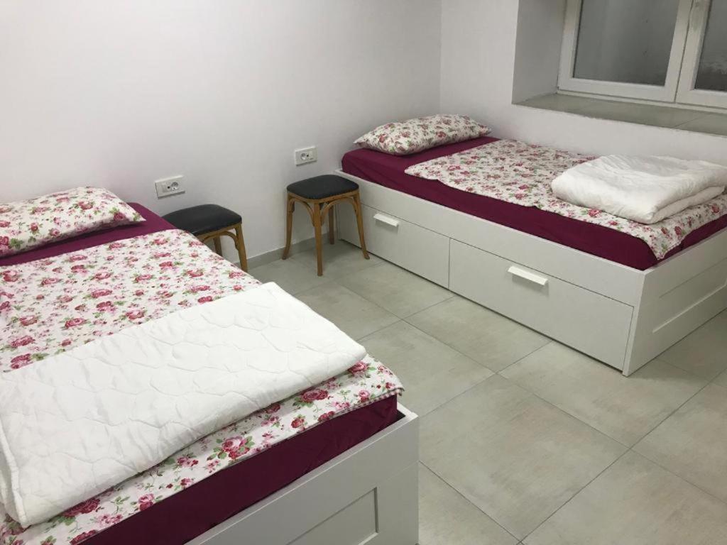 two beds in a room with at Studio Ljubljana in Ljubljana