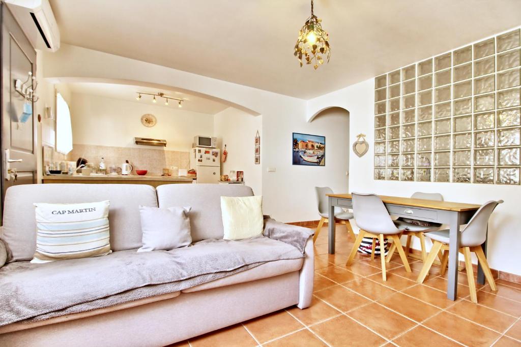 a living room with a couch and a table at Appartement T2 Prunello By Intendance Excellency in Porto-Vecchio