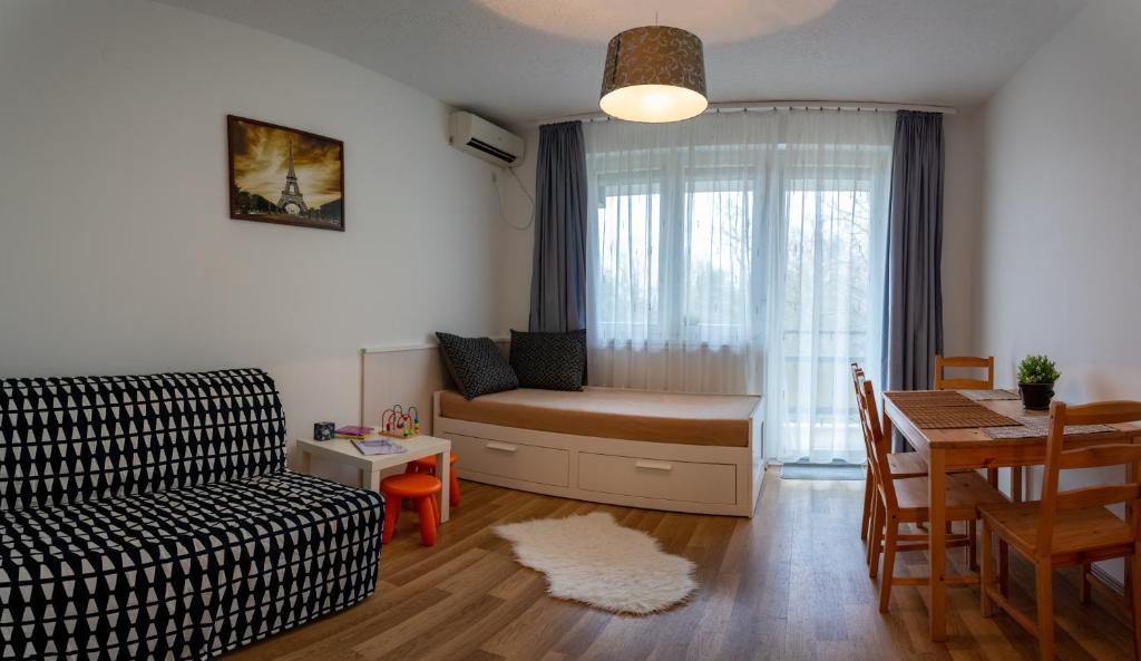 a living room with a couch and a table at Helikon 32 Apartman Keszthely in Keszthely