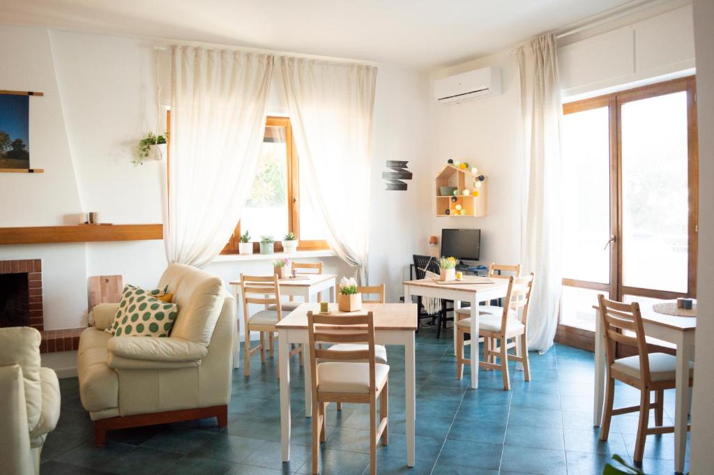 a living room with chairs and a table and a couch at PURA B&b in Noicattaro