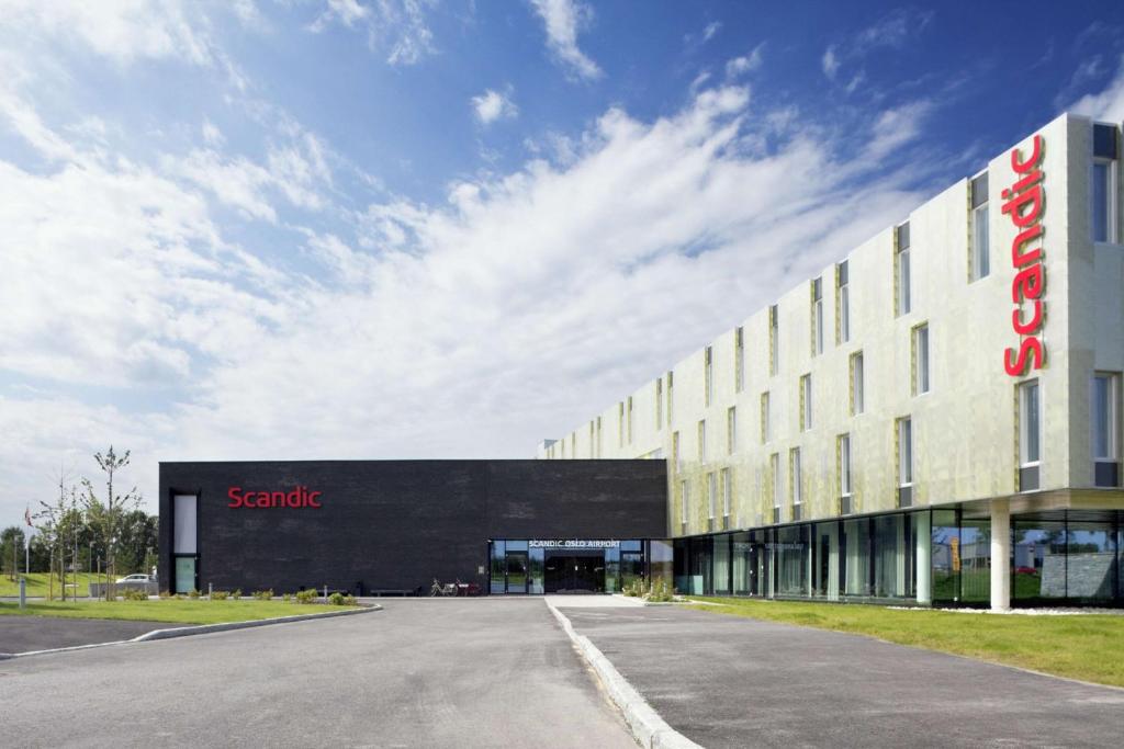 a large building with a sign on the side of it at Scandic Oslo Airport in Gardermoen