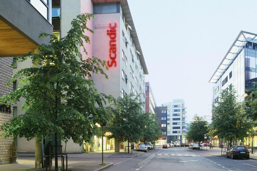 a building with a sign on the side of a street at Scandic Sjølyst in Oslo