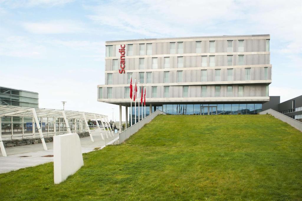 a building with a lawn in front of it at Scandic Stavanger Airport in Sola