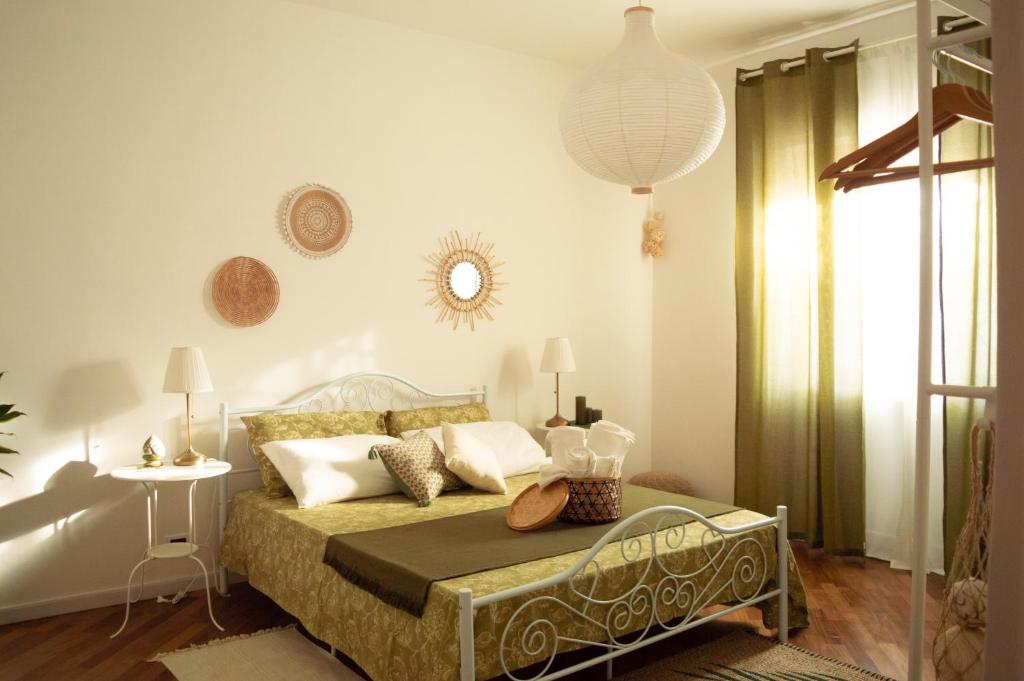 a bedroom with a bed and a table and a mirror at PURA B&b in Noicattaro