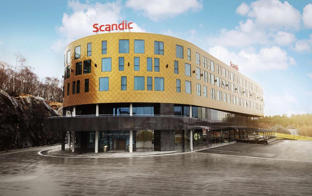 a large yellow building with a santenna sign on it at Scandic Flesland Airport in Bergen