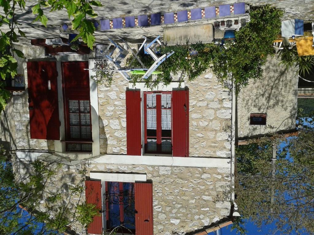 an old stone house with red doors and windows at B&B Le Clos des Cigales in Cassis