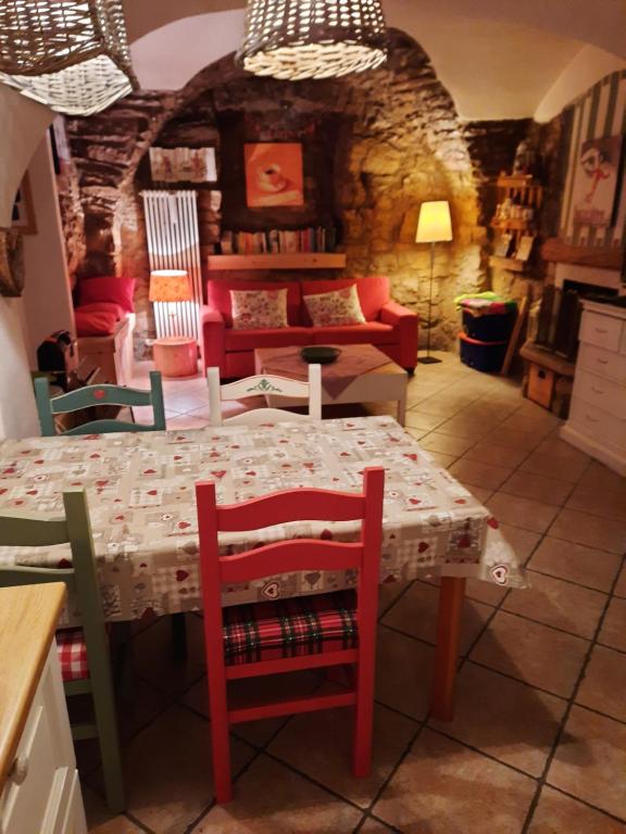 a kitchen with a table and chairs and a couch at Appartamento Sopramonte in Trento