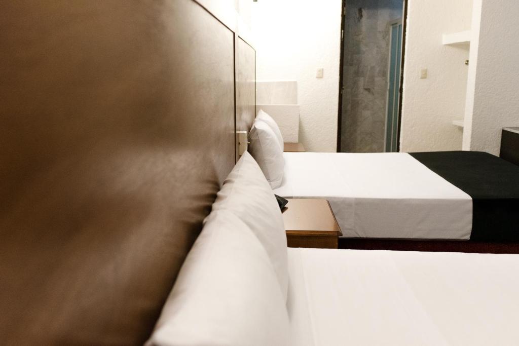 Postel nebo postele na pokoji v ubytování Hotel Central Irapuato - Hotel en Irapuato
