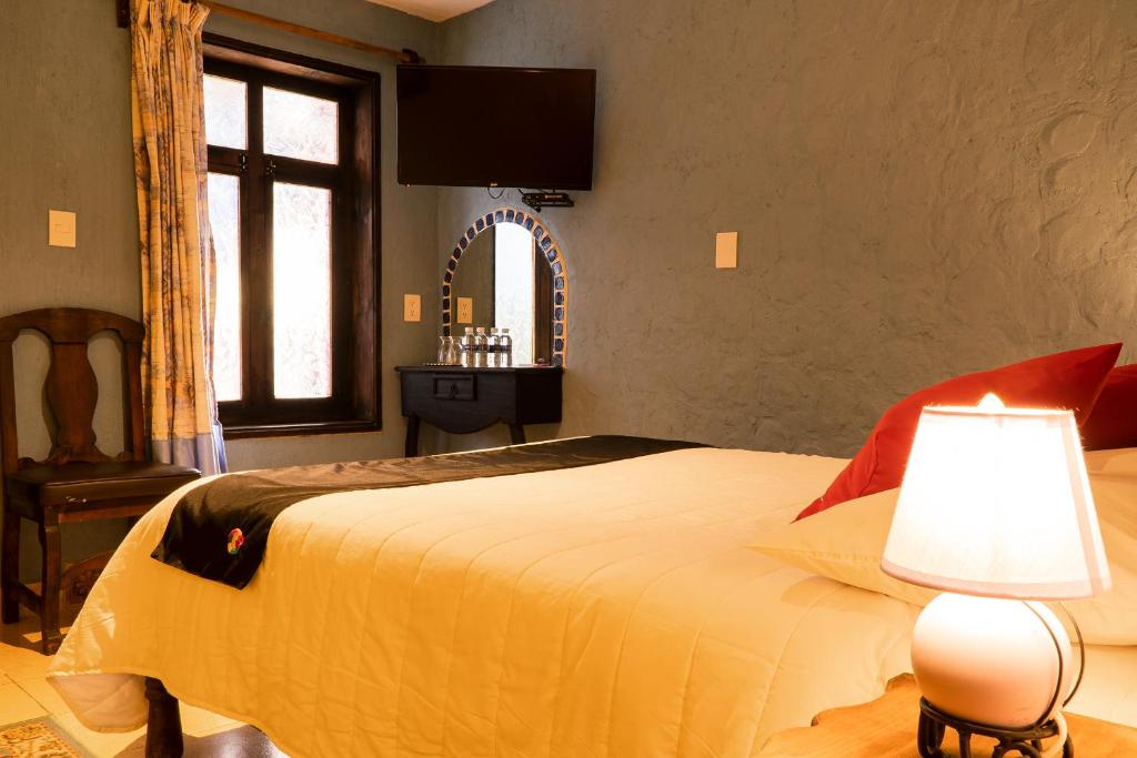 Postel nebo postele na pokoji v ubytování Hotel Tepeyac