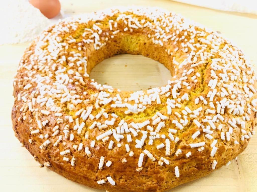 a doughnut with powdered sugar on top of it at Hotel Milanese in Rimini