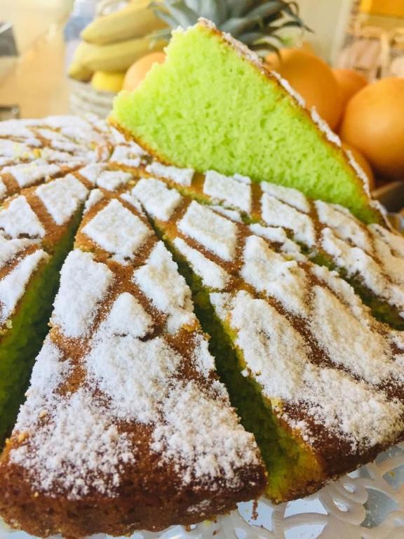 a piece of cake with powdered sugar on top of it at Hotel Milanese in Rimini