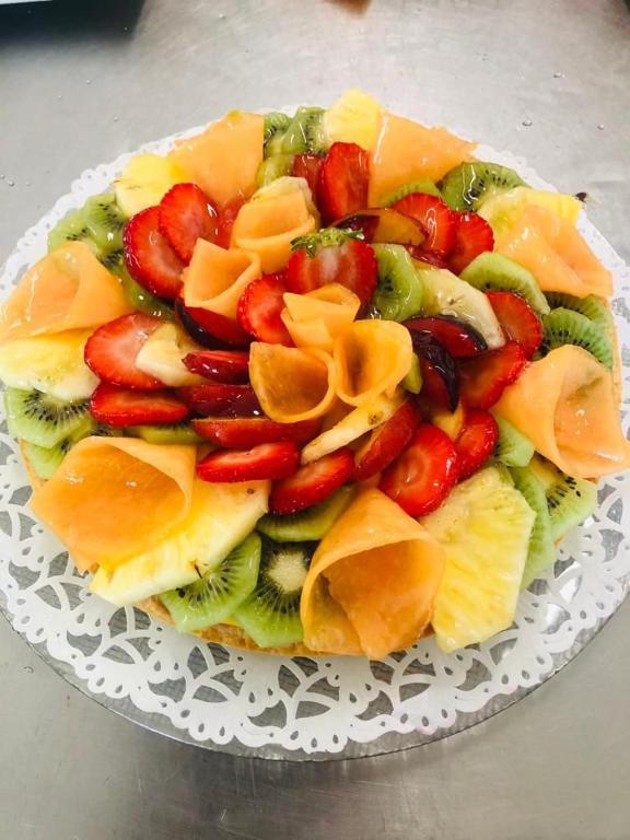 a plate of fruit and vegetables on a table at Hotel Milanese in Rimini