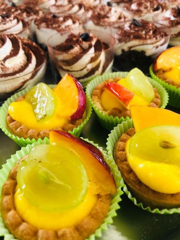 a bunch of cupcakes with yellow frosting on them at Hotel Milanese in Rimini