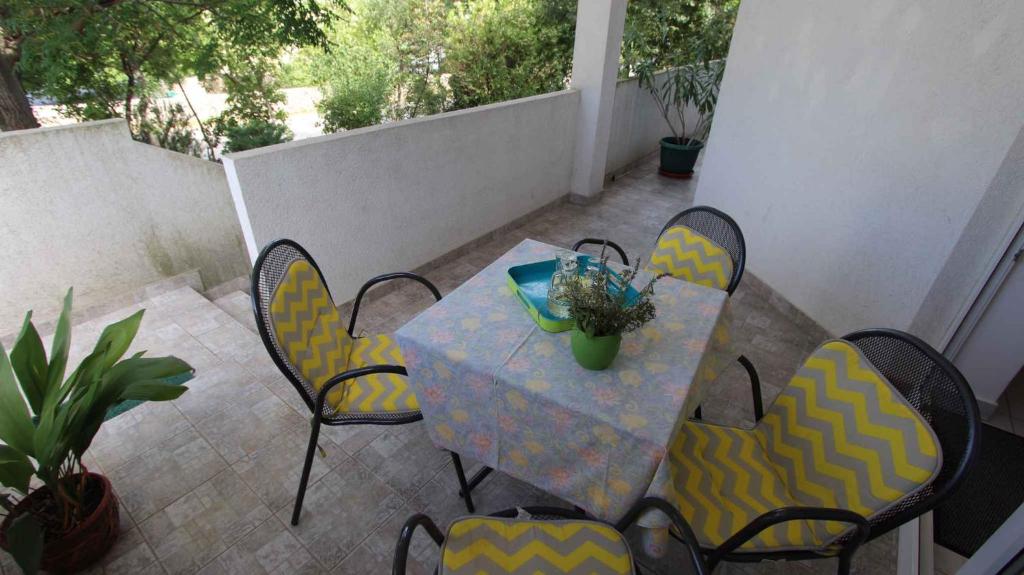 a patio with a table and chairs on a balcony at Apartment Klimno 1 in Klimno