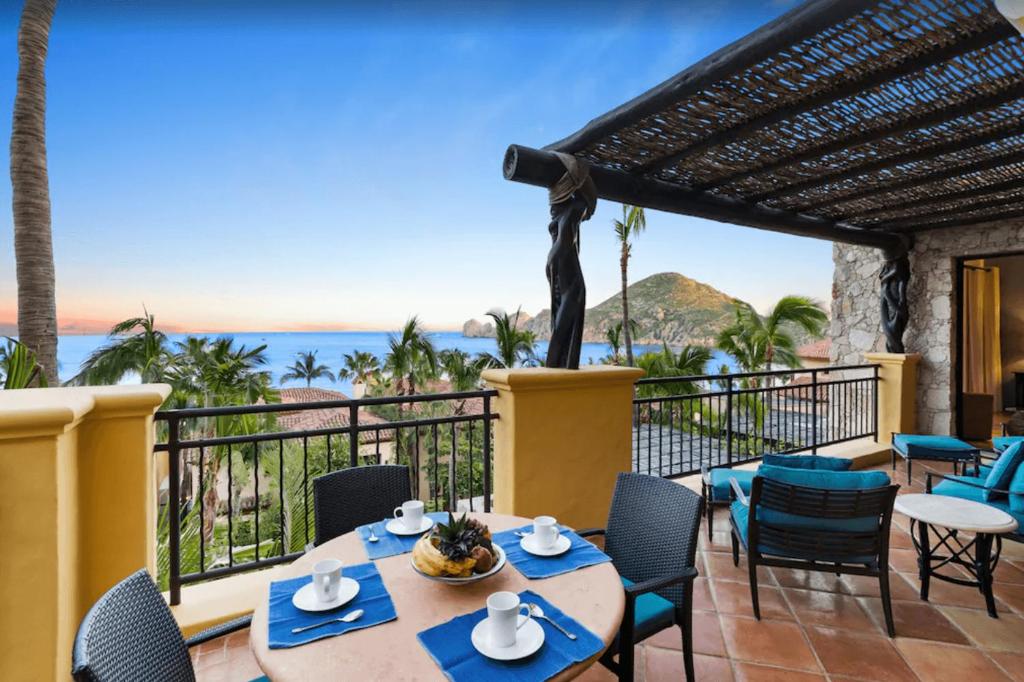 a patio with a table and chairs with a view of the ocean at Best Executive-Style Luxury Residence on Property in Cabo San Lucas