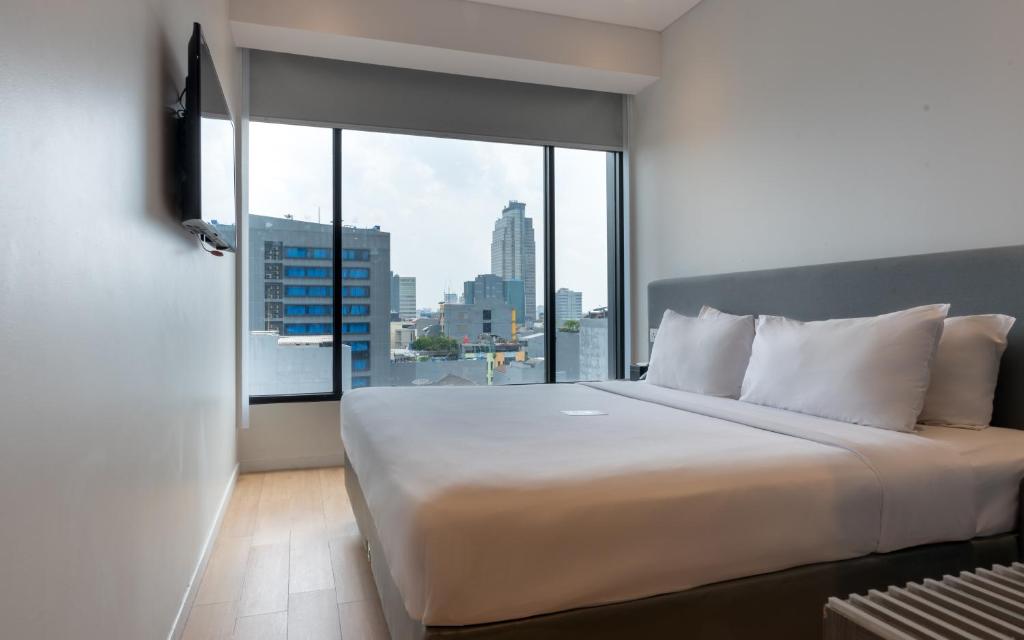 Ένα ή περισσότερα κρεβάτια σε δωμάτιο στο Juno Tanah Abang Jakarta