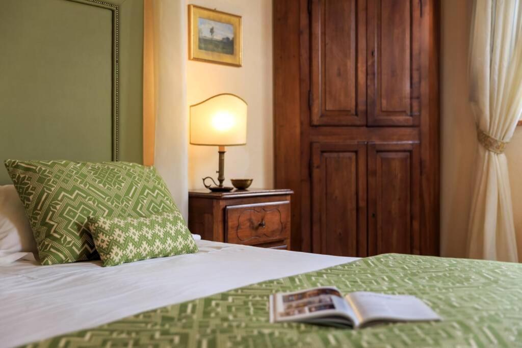 A bed or beds in a room at Podere Maiano - Private pool villa with spa