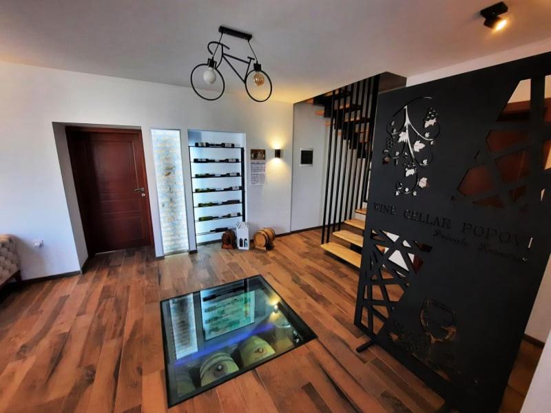 a living room with a bike hanging on the wall at Wine cellar Popovi Apartments in Kavadarci