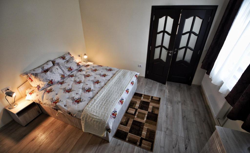 Schlafzimmer mit einem Bett und einer schwarzen Tür in der Unterkunft FLORI'S Apartment in Braşov