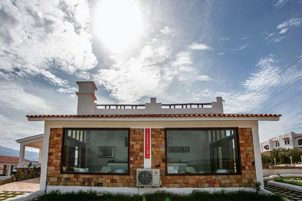 a small brick building with the sun in the sky at Bungalow Double 14 - El Cortijo Chefchaeun Hotel Spa in Chefchaouene