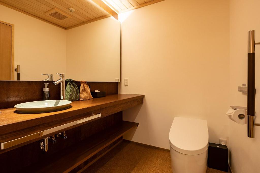 a bathroom with a sink and a toilet at 祇園の宿 杏花 in Kyoto