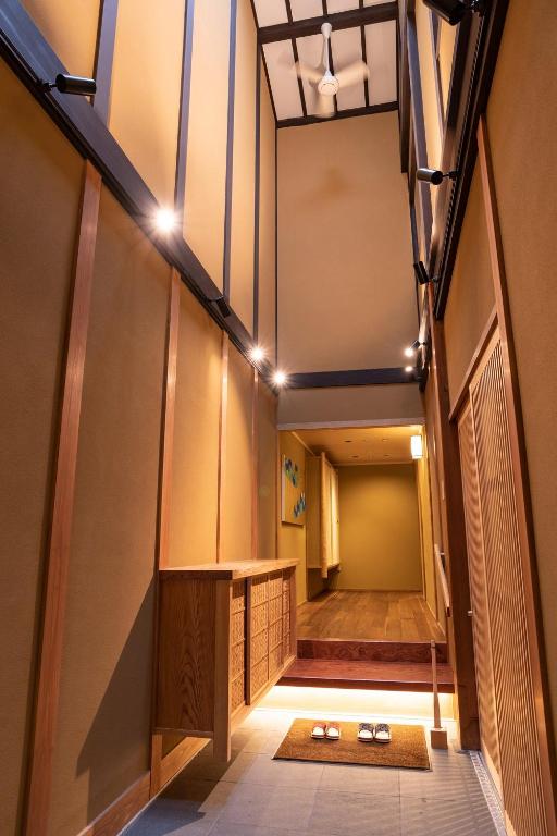 a hallway of a building with a table and lights at 祇園の宿 杏花 in Kyoto