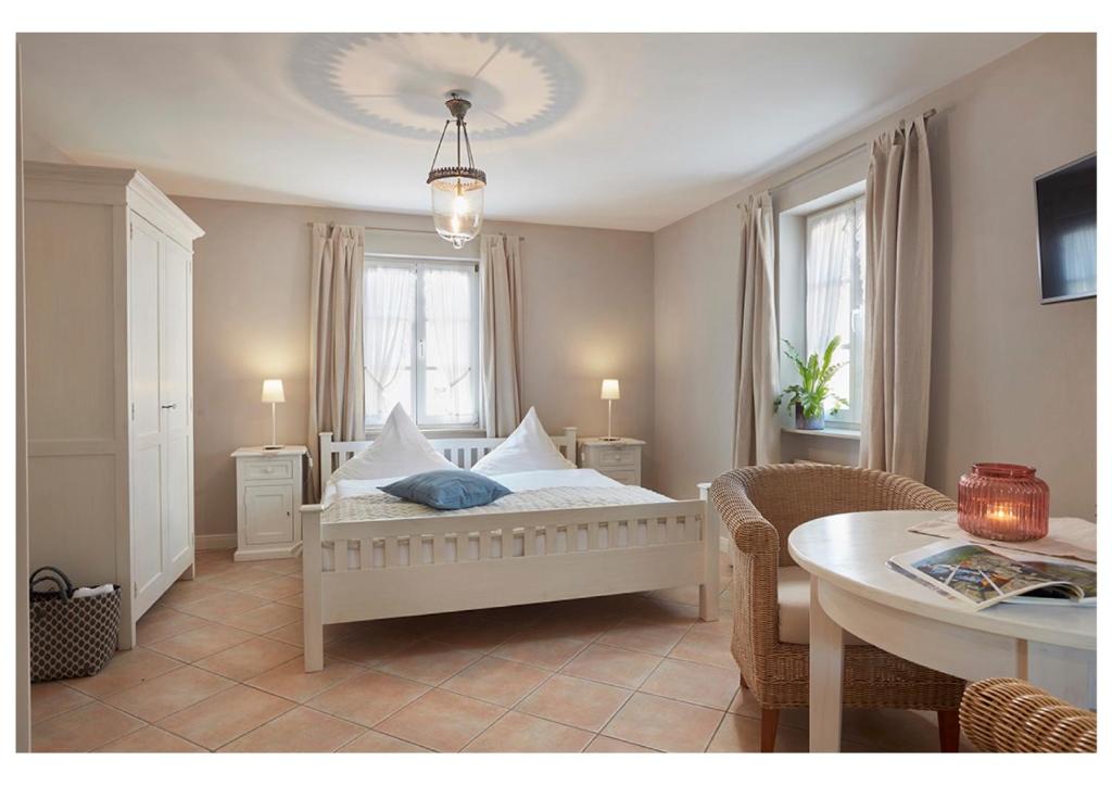 1 dormitorio con cama con almohadas y mesa en Weingut & Gästehaus GiwerGreif en Wasserliesch
