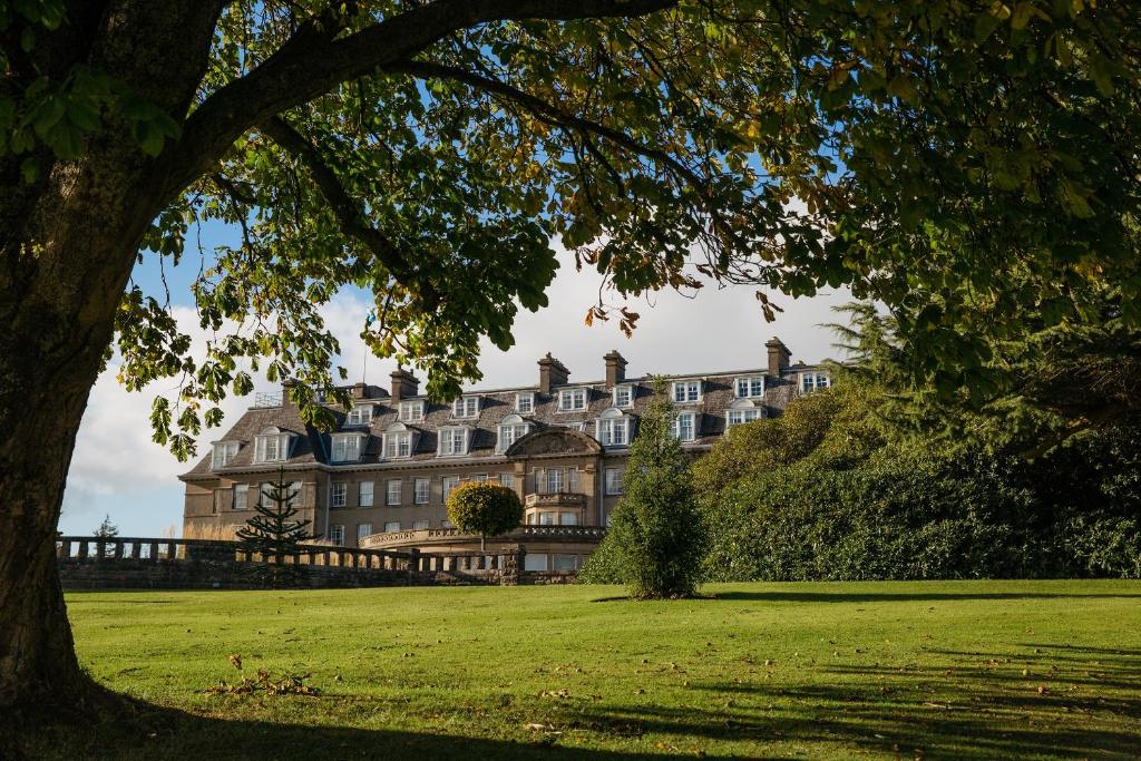 a large building on top of a lush green field at The Gleneagles Hotel in Auchterarder