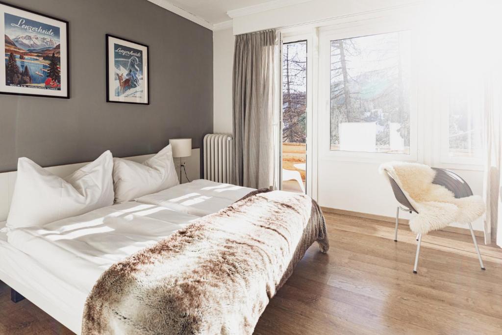 Postel nebo postele na pokoji v ubytování Kurhaus Lenzerheide