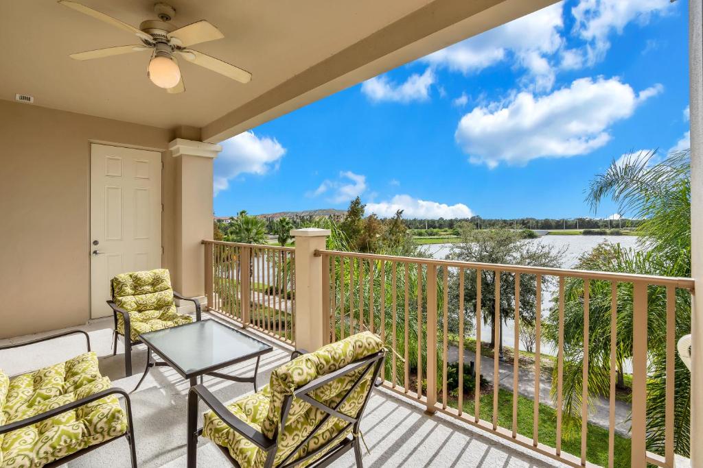 a balcony with a table and chairs and a view of the water at 4816 Cayview Ave #306 in Orlando
