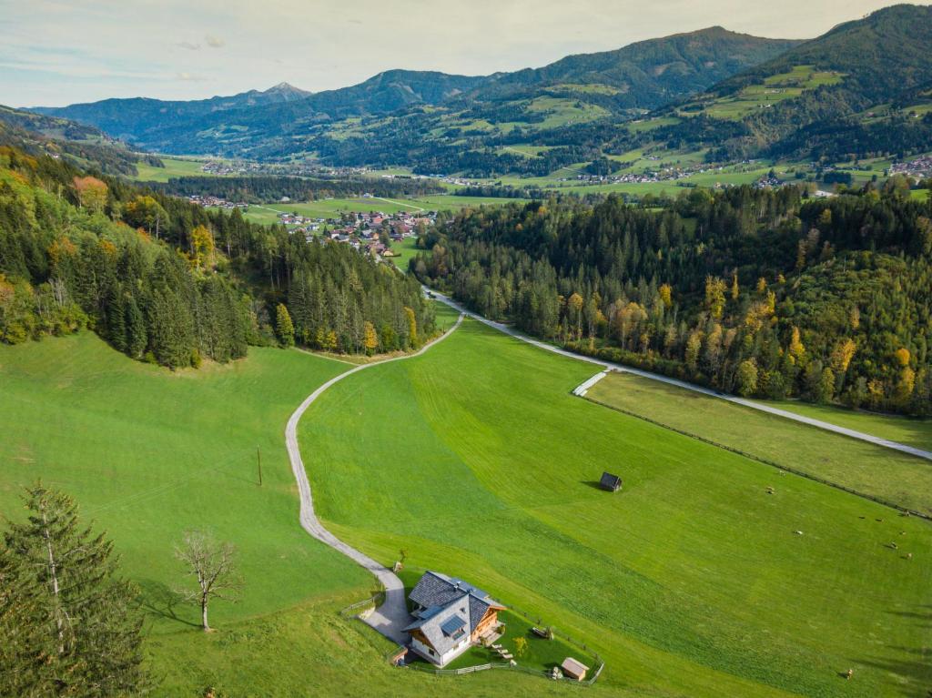 an aerial view of a green field with a road at Almchalet Linharterhof in Haus im Ennstal