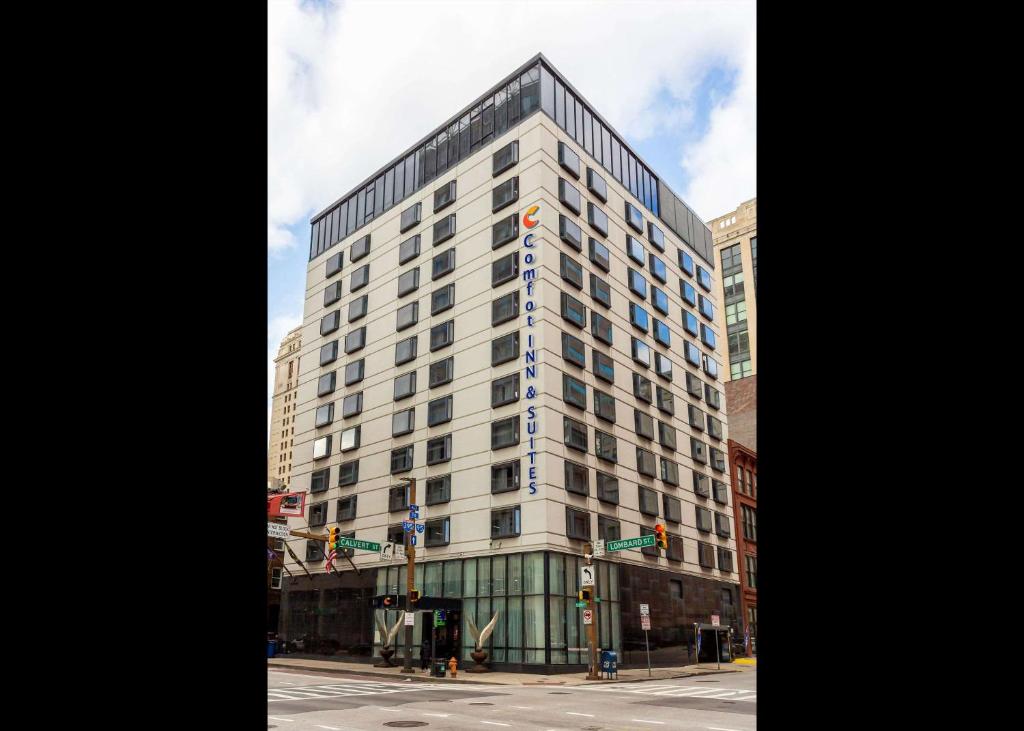 a tall white building on a city street at Comfort Inn & Suites Baltimore Inner Harbor in Baltimore