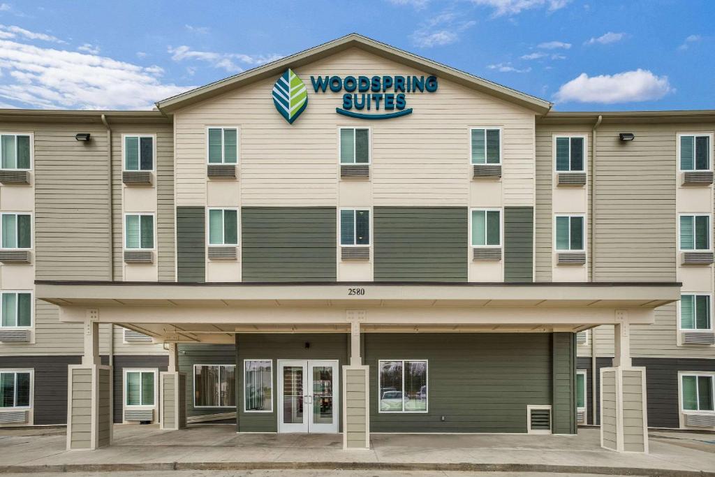 un edificio con un cartel de club de lucha. en WoodSpring Suites Sulphur - Lake Charles, en Sulphur